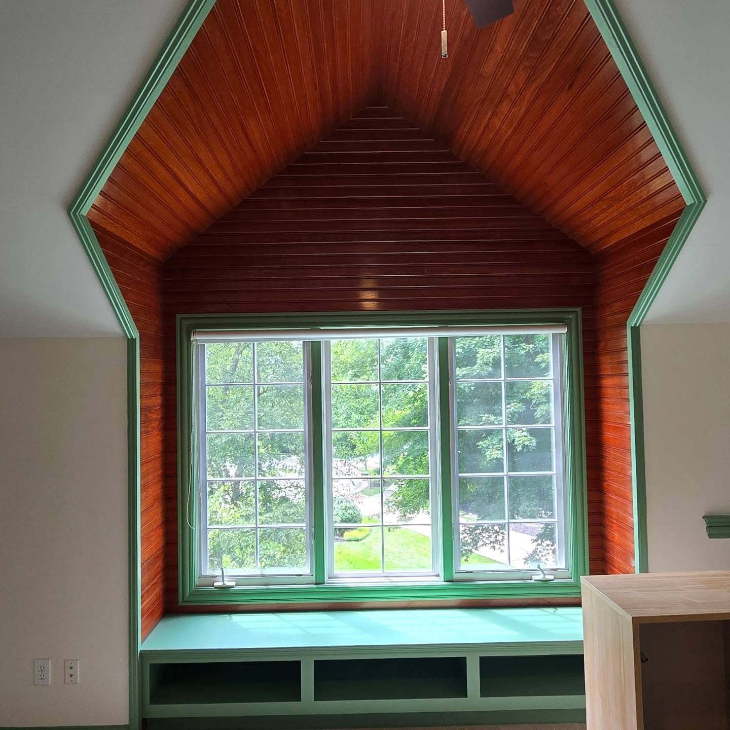 Green painted trim, finished walls and ceiling, and stained beadboard by Advanced Carpentry Services